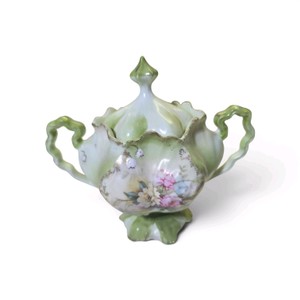 Antique sugar bowl is a piece of R.S. Prussia porcelain, featuring a light green and white color scheme with a hand-painted floral design
