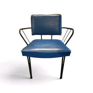 Vintage mid-century modern armchair features a blue vinyl seat and a black metal frame.