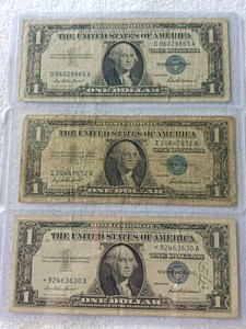 Lot of (3) 1957 $1 United States Silver Certificates - Blue Seals (Circulated)  a star note