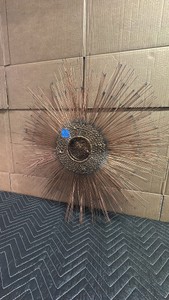 This vintage Mid-Century Modern sunburst sculpture appears to be a metal art piece
