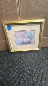 Framed artwork of floral print by artist Lena Liu, featuring a delicate watercolor style and a gold-toned frame