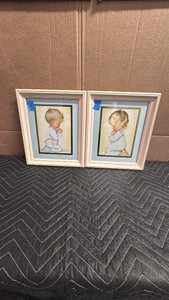 A pair of vintage Charlot Byj framed prints titled A Childs Prayer and Bless Us All, featuring a boy and a girl kneeling in prayer.
