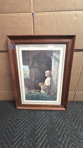 Framed vintage print is titled Summer Daydream (or Summer Day Dreams) by American artist Adolf Sehring, featuring a young girl holding a basket of wildflowers near a rustic barn window