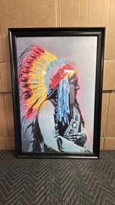 Signed portrait of Native American chief with a brightly colored feathered headdress