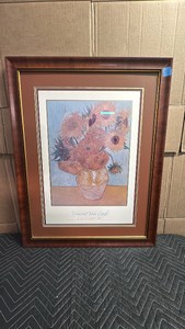 Framed fine art print of Vincent van Goghs iconic Sunflowers still-life series, matted in a rich rust-toned border and housed in a classic polished wood grain frame