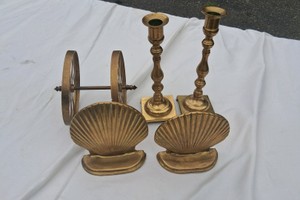 BRASS BOOKENDS, CANDLE HOLDERS, AND WHEELS
