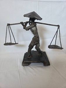 Metal upcycled Chinese water carrier sculpture