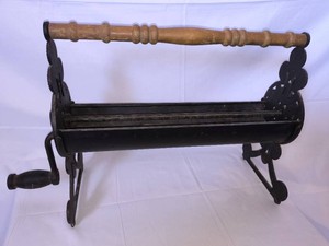 Vintage Cast Iron Newspaper Log Roller