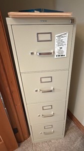 HOM  four drawer file cabinet with a box of file folders and index sheets