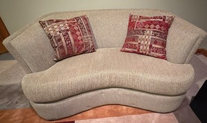 oval shaped tanbeige upholstered love seat
