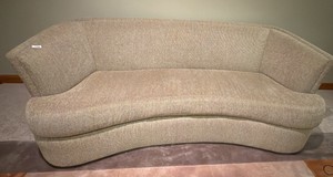 oval shaped beige tan upholstered sofa