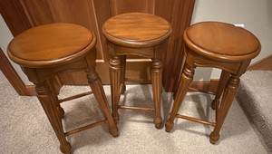 three wooden 24 inch high stools