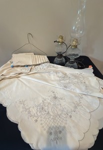 vintage tablecloth with embroidery and napkins, and two electric style oil lamps