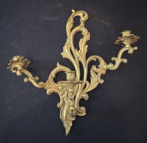 vintage Rococo-style ornate solid brass or bronze 3-arm candle wall sconce with scrolling acanthus leaf and floral scrollwork motifs.