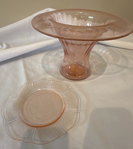 vintage pink depression glass pedestal compote bowl featuring a wide rim with an etched leaf and vine design and plate