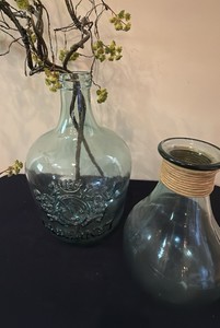 a Vidrios San Miguel handmade Spanish recycled glass Cabernet wine jug with an embossed crest and green tint and a another glass style vase