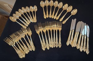Gold tone, eight piece flatware set