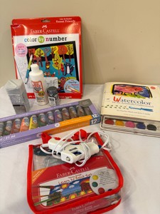 Collection of art supplies--unopened acrylic paints, color by number, glue gun with extra sticks in bag, glitter, and watercolor book