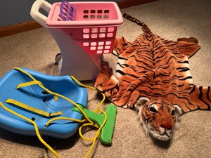 Little Tikes shopping cart and outdoor plastic swing plus a tiger throw
