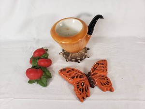 Orange Pipe-Shaped Planter, Red Apple Decor, and Orange Butterfly Wall Plaque