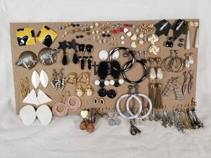 Lot of assorted earrings in various styles and designs including elephants, hoops, studs, dangle, and themed pieces.