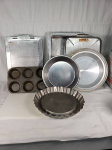 Assorted Kitchen Bakeware Including Ekco Bakers Secret Pie Pan and Muffin Tin, Cutting Board, Baking Sheets, and Cake Pans