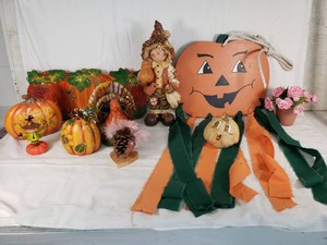 Fall Themed Figurines and Decorations Including Scarecrow, Pumpkin Art, and Ceramic Turkey