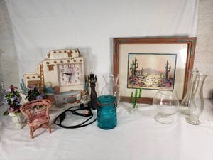 Various decorative household items including Avon Blue Glass Jar, Desert Landscape Art by Kathleen English-Pitts, and Burwood 1995 Pueblo Clock
