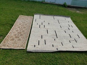 Two area rugs including a floral patterned runner and a modern abstract rug