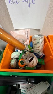 bucket of various rolls of tape