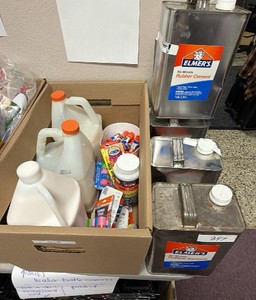 four containers of Elmers no wrinkle rubber cement two brand new Elmer school glue one and a half containers Amazon glue 1 gallon brand new several blue sticks some brand new impact