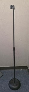 three microphone stands with two microphones and cord