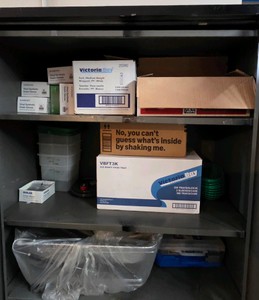 three shelves of assorted gloves, tray sleeves and misc