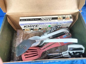 Box contains a variety of kitchen preparation and cooking tools.