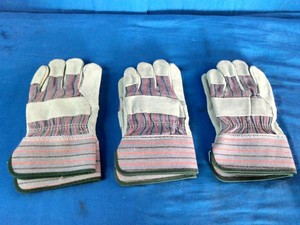Safety work gloves feature a durable gray leather palm and striped fabric back.