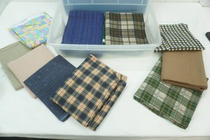 variety of fabric pieces in differant sizes in storage tote with lid