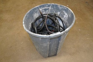 Garbage Can with Air Hoses and Extension Cords