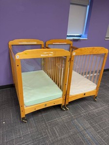 Pair of Compact Wooden Window Crib features clear acrylic panels at both ends for high visibility. Wooden Daycare Baby Cribs With Mattresses on Casters. Each Retails for $375