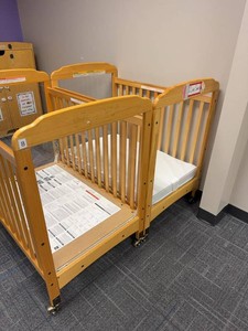 Pair of Compact Wooden Window Crib features clear acrylic panels at both ends for high visibility. Wooden Daycare Baby Cribs With Mattresses on Casters. Each Retails for $375