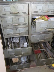(2) Metal 8-drawer storage cabinets plus content to include a large assortment of metal parts and scrap each cabinet approx 15x25x52.5in