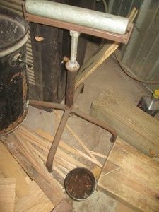 Metal sheet bending stand, metal bucket, Billard Barbell weights and pile of wood scrap