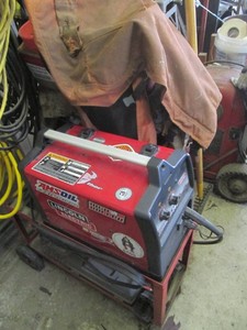 Lincoln Electric Power Mig 140c welding machine with rolling work station, rolls of Flux core wire, protective chaps and more
