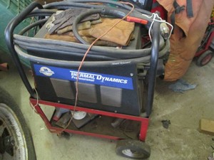 Thermal Dynamics Professional Cut master 51 plasma cutter with hose and handheld attachment end on portable cart