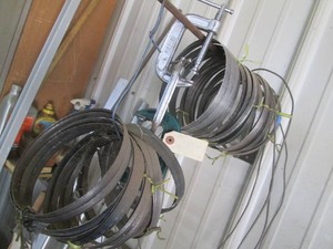 Collection of band saw blades and c-clamps