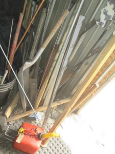 Corner lot to include a variety of metal tripods, sledgehammers, scoop shovel, ice chipper and more