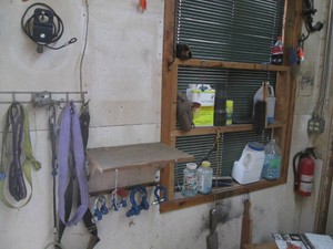 Content on wall and window sill to include a variety of hardware, ax heads, chemicals and more