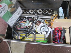 Content of toolbox drawer to include metal building tape, Torque Wrench, 34in ratchet and socket set, spring benders and more
