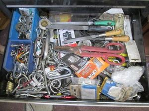 Content of toolbox drawer to include a collection of carabiner, eye hooks, Tim snips and other hardware