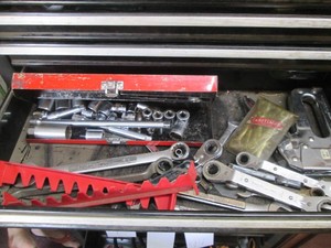 Content of toolbox drawer to include box wrenches, Craftsman combination wrenches, misc sockets, stapler and more
