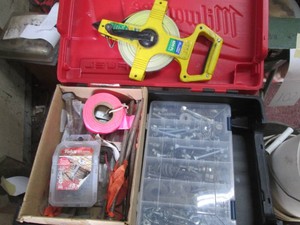 Milwaukee hardside vase containing a 100ft tape measure, hardware organizer and hardware